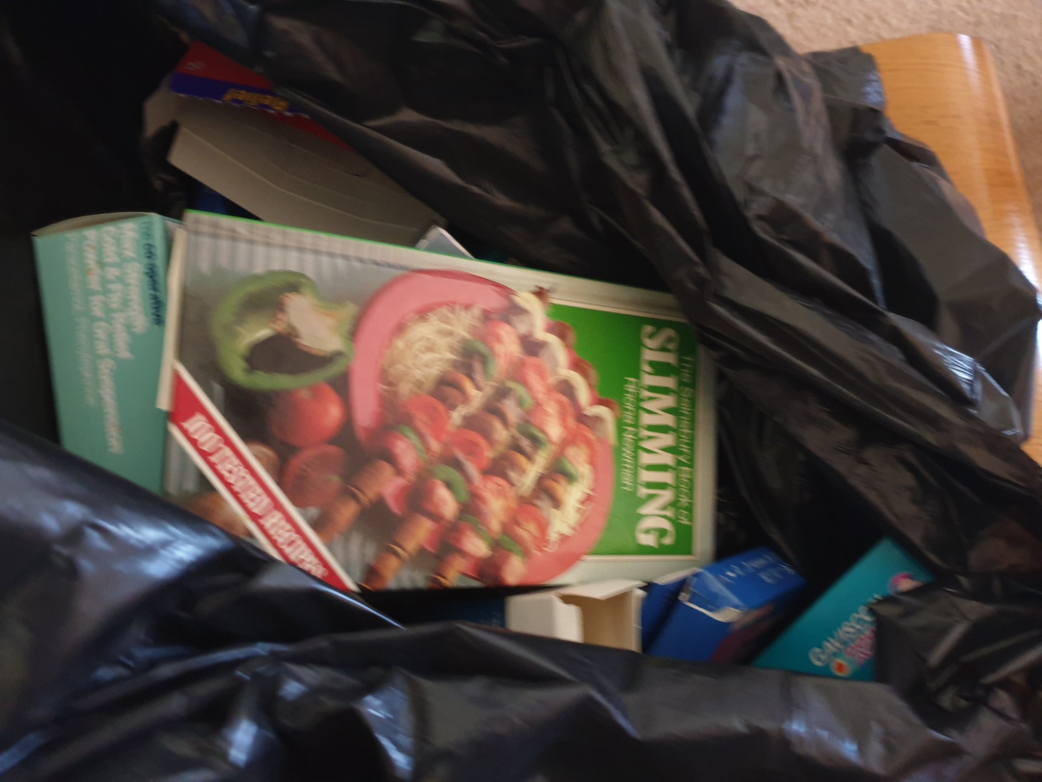 The book, in a bin bag ready to be thrown away