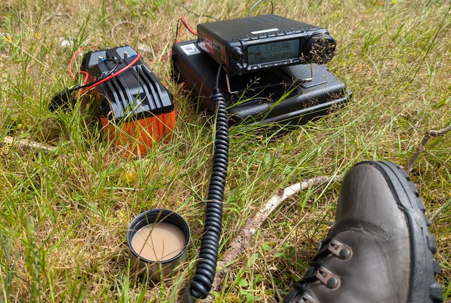 POTA radio station: FT-891, giant battery, cup of tea, walking boot.