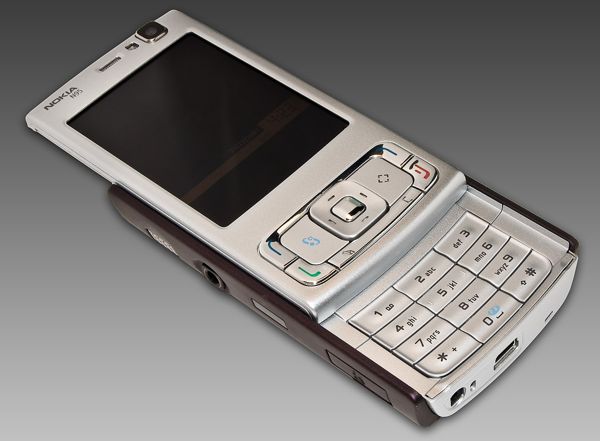 Candybar phone with large screen and slide-out keypad
