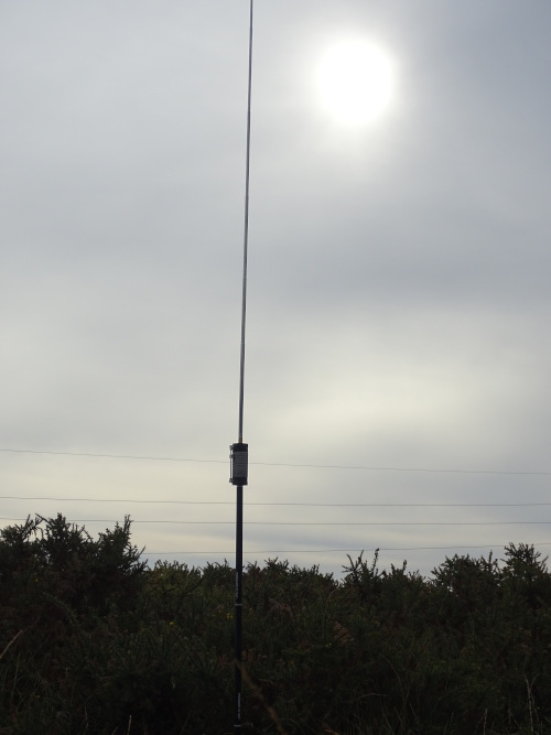 JPC-12 antenna silhouetted against a misty sky