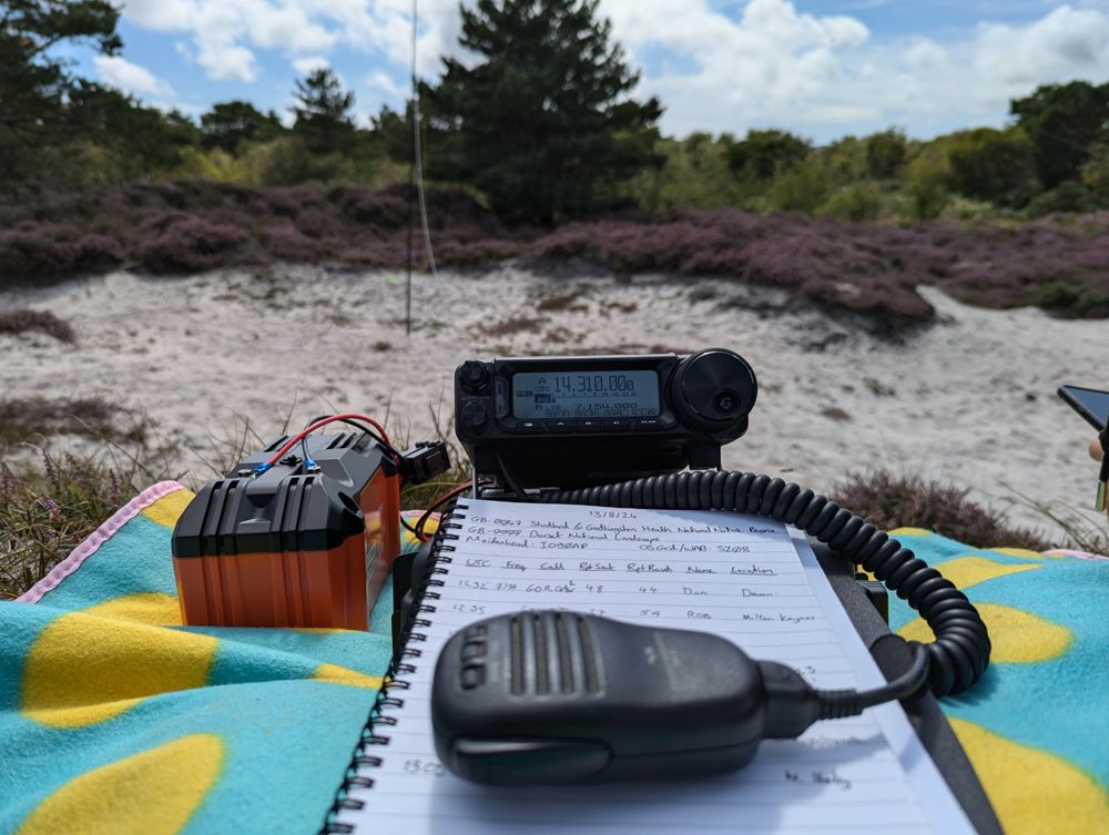 Radio equipment in the foreground, antenna pole somewhat out of focus in the background.