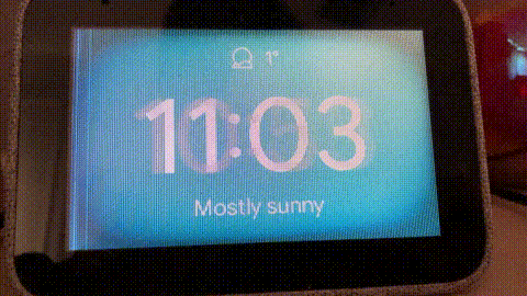 A Lenovo Smart Clock with a display fault that makes the screen flicker