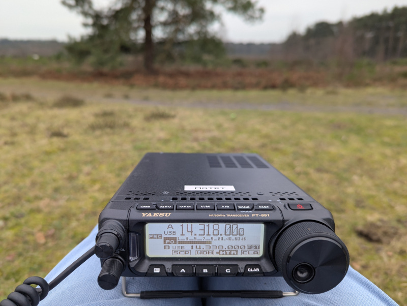 Yaesu FT-891 on my knees, park in the background