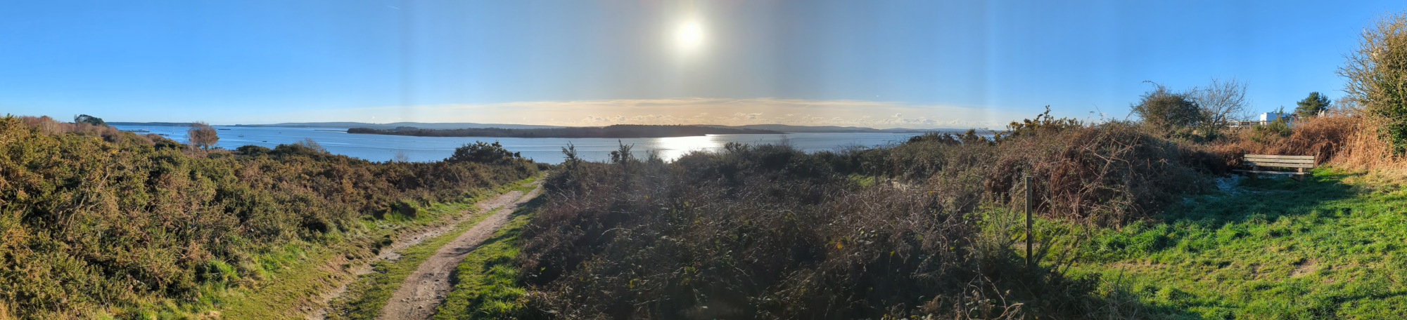 Panorama of Poole Harbour and a trail leading down towards the water