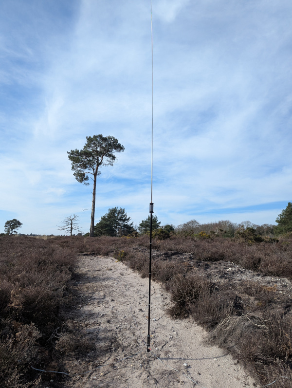 JPC-12 antenna with heathland and a tree in the background