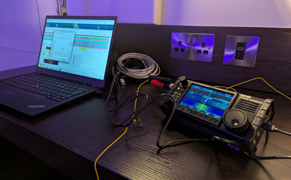 X6100 and laptop set up on a desk, with the laptop showing WSJT-X software