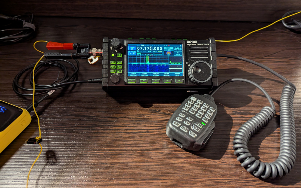 X6100, fist mic and power supply set up on a desk, with the radio showing an LSB signal on 7192kHz.