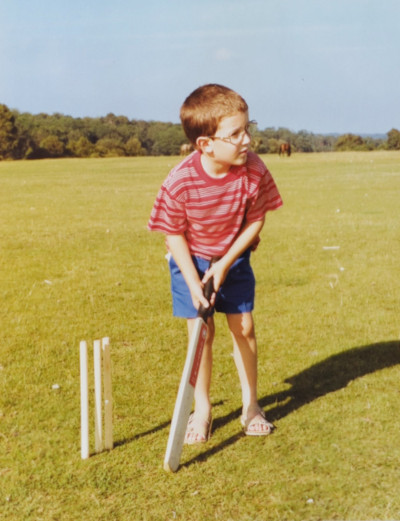 Five-year-old me batting in front of some stumps at Longslade Bottom