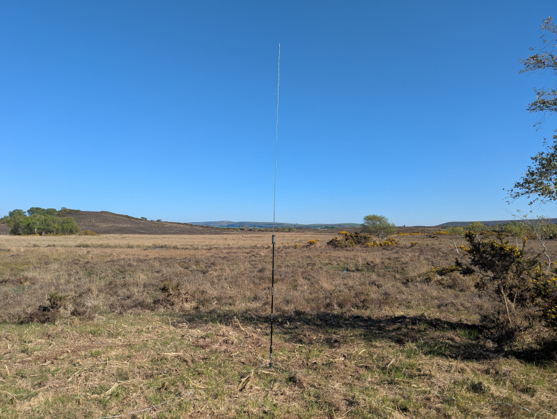 Antenna in the foreground, heathland and a single steep hill in the background