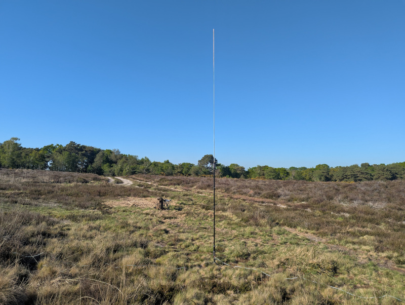 Antenna in the foreground, rucksack and seat behind it, on heathland