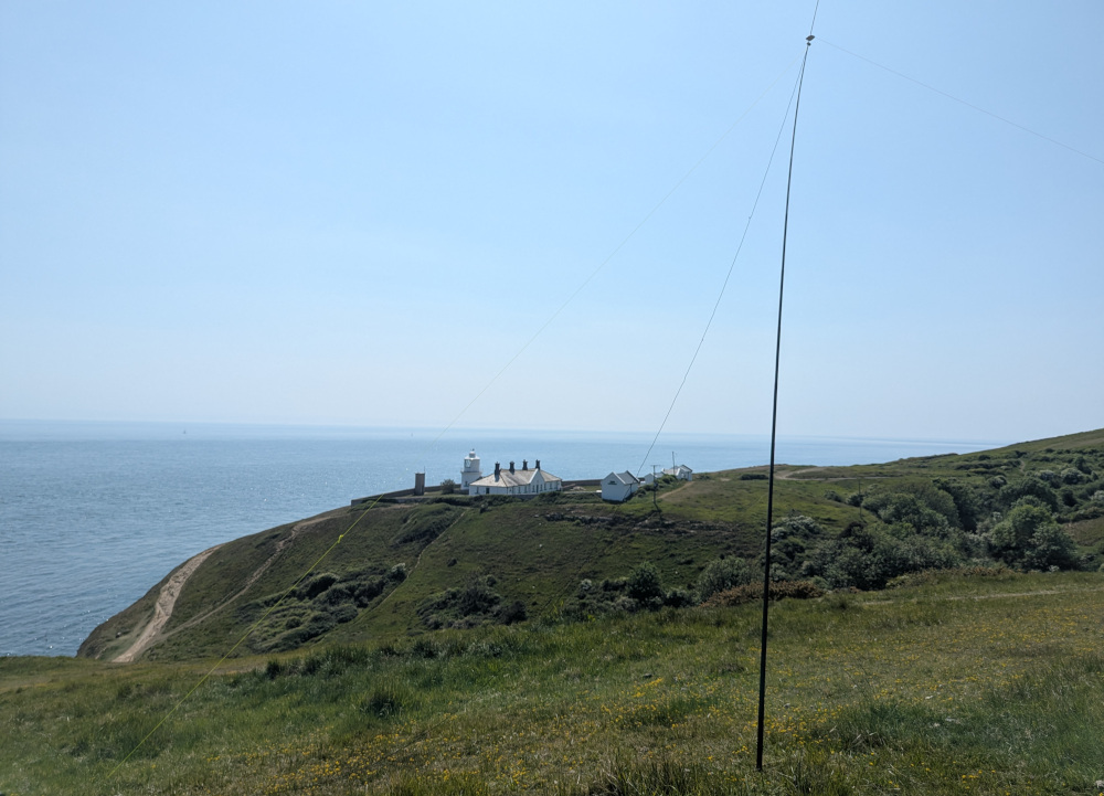 Inverted V dipole antenna with Anvil Point lighthouse behind it