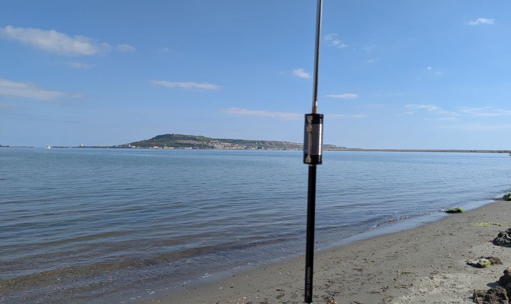 Small beach with an antenna, Portland in the background