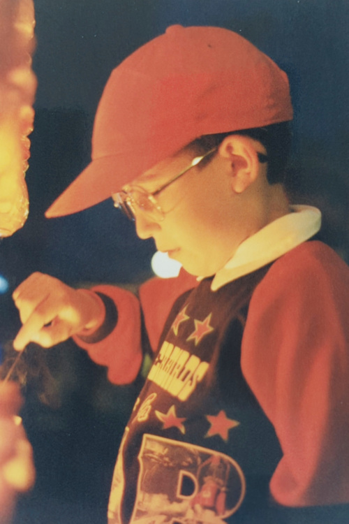 7-year-old boy lighting tea lights with a taper