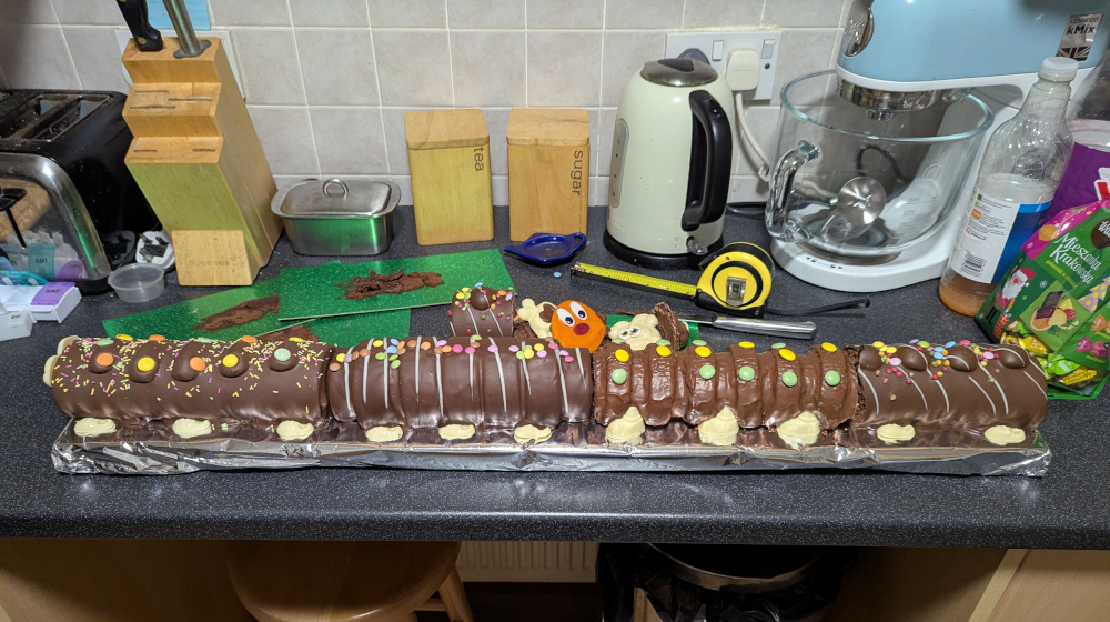 Gigawiggles construction shot showing the assembled cakes on the board with chocolate covering the gaps