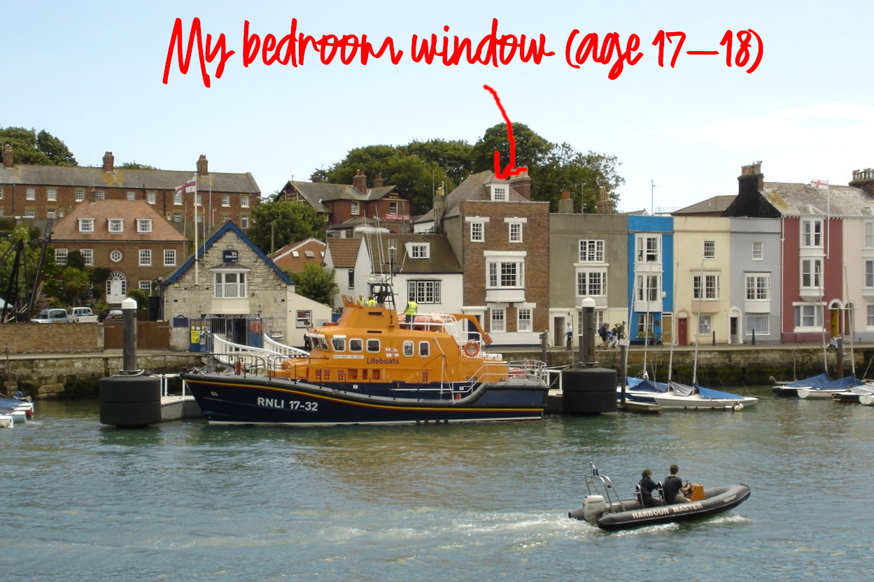 Photo of town houses on Weymouth harbour side. A third-storey window in one of the houses is labelled "My bedroom window, age 17-18".