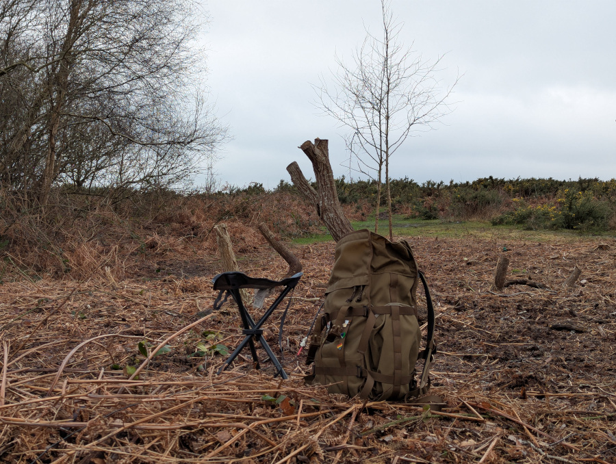 Rucksack and tripod chair on a patch of brown bracken