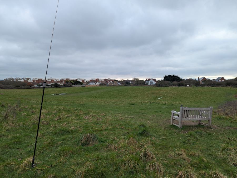 JPC-12 antenna next to a wooden bench overlooking a field