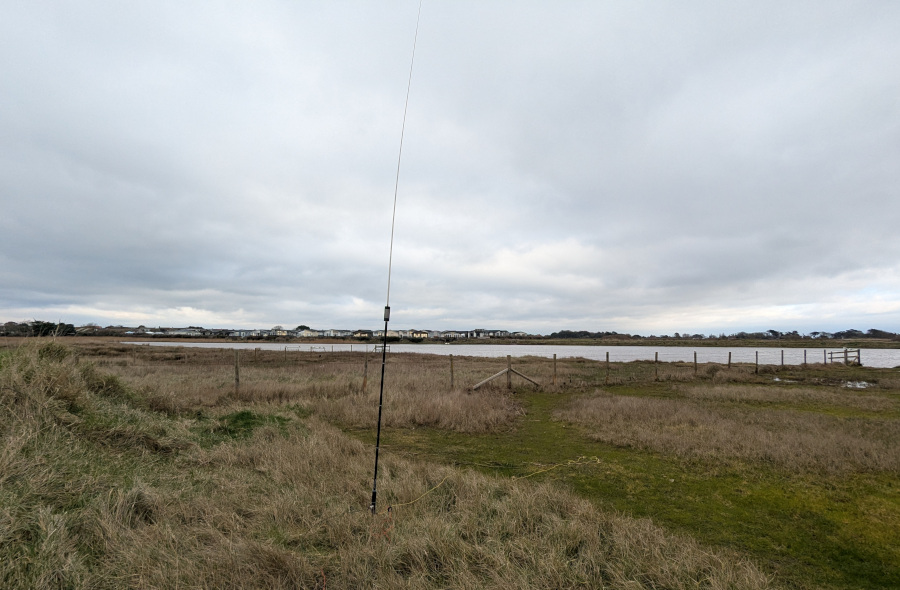 JPC-12 antenna in front of a small lake with holiday homes in the background