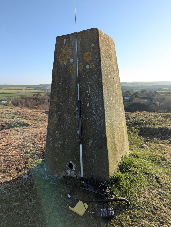 Antenna propped up on trig point
