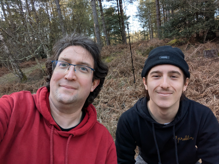 Two idiots grinning in front of an antenna