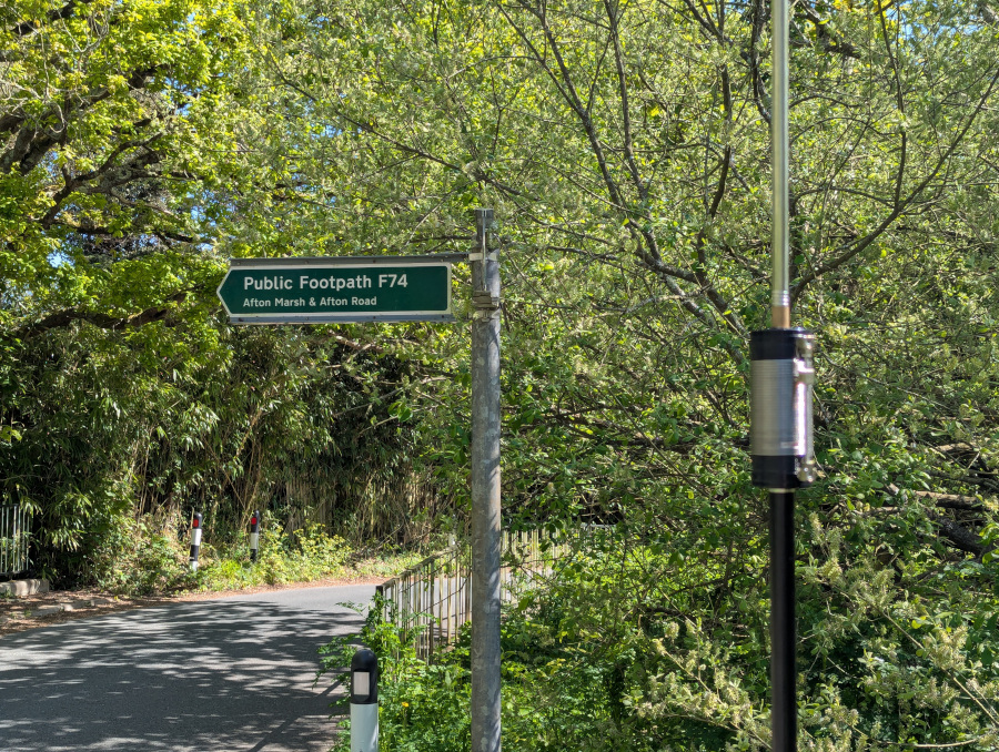 Close-up shot of JPC-12 vertical antenna loading coil next to an Afton Marsh footpath sign