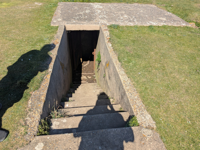 A concrete bunker with steps going into the ground