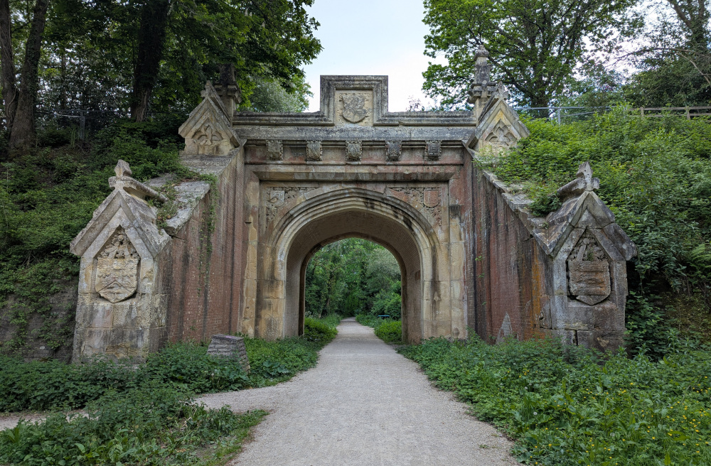 Large imposing stone bridge over a path