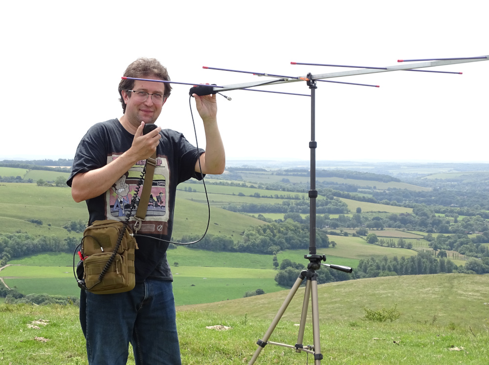Me with my FT-817 handbag and antenna, making a QSO