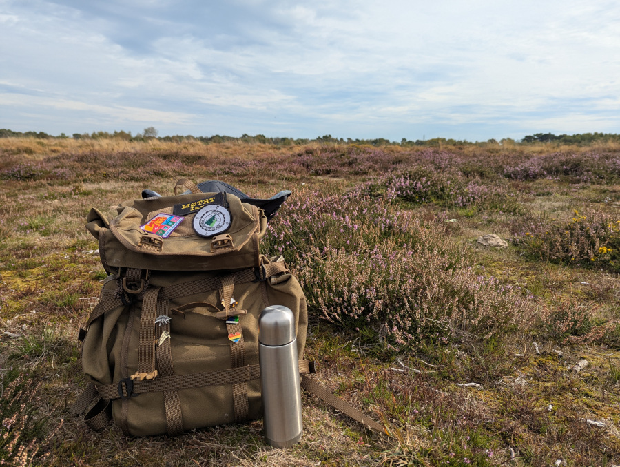 Rucksack and thermos on a brown heath