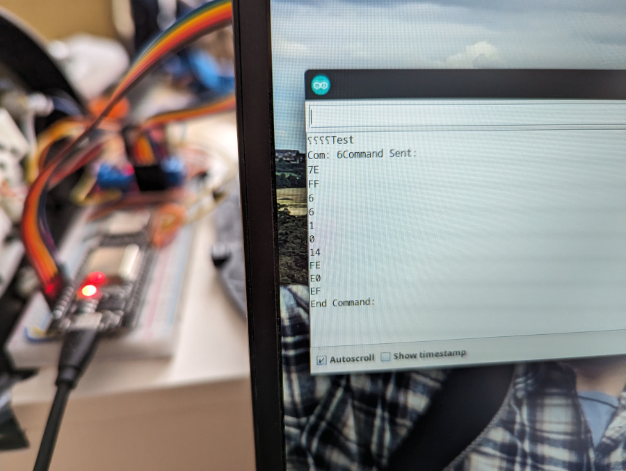 A photo of a screen showing a serial monitor window with some debug information, and the project in the background