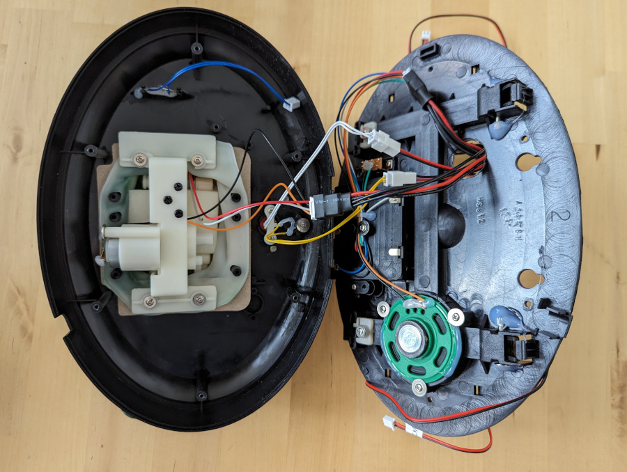 Two halves of an open Billy Bass with existing cabling attached to cable extenders