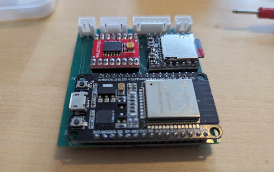 Three main components and four JST connectors on a PCB motherboard