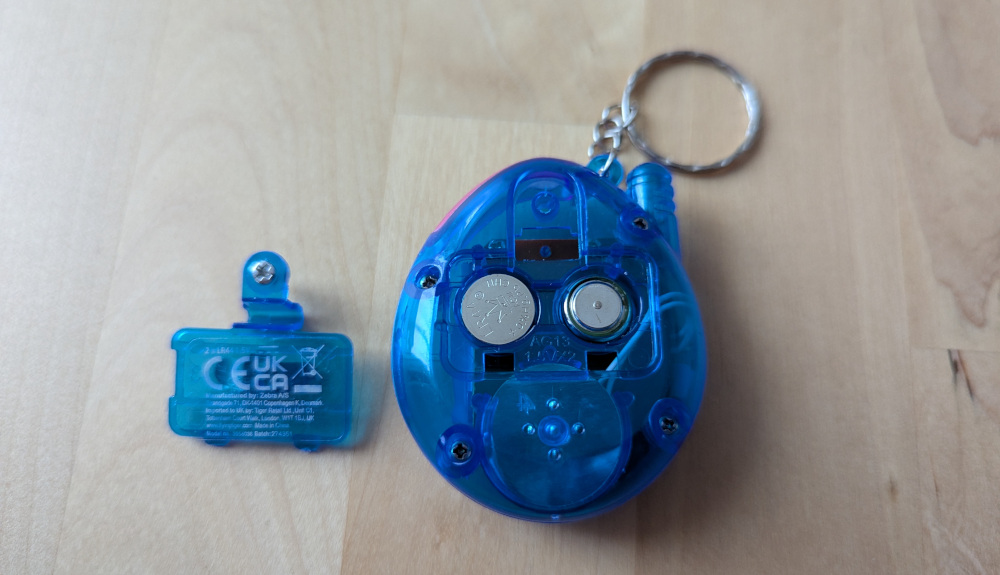 Photo of rear of virtual pet device with battery compartment open